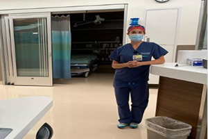 Dr. Christanne Coffey standing in scrubs in an empty ER