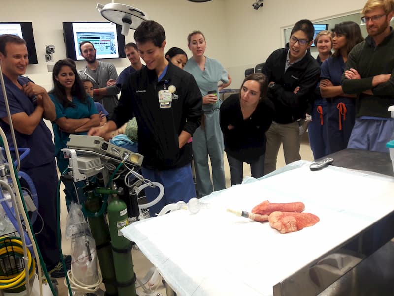 group of emergency med physicians and students participating in a simulation 